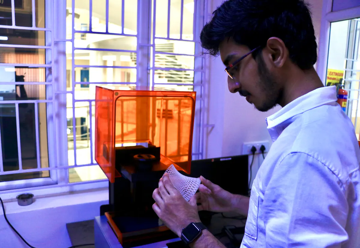 Spezar engineer inspecting a 3D-printed prototype in the workshop